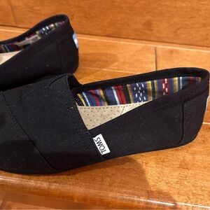 TOMS Black Slip-On Shoes with Striped Interior